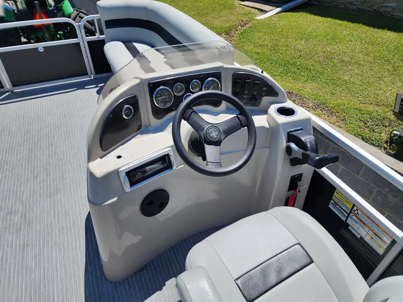 Slide: The Image of Steering console of a 2012 Sweetwater SW 2086 pontoon boat with gauges and controls. - 6