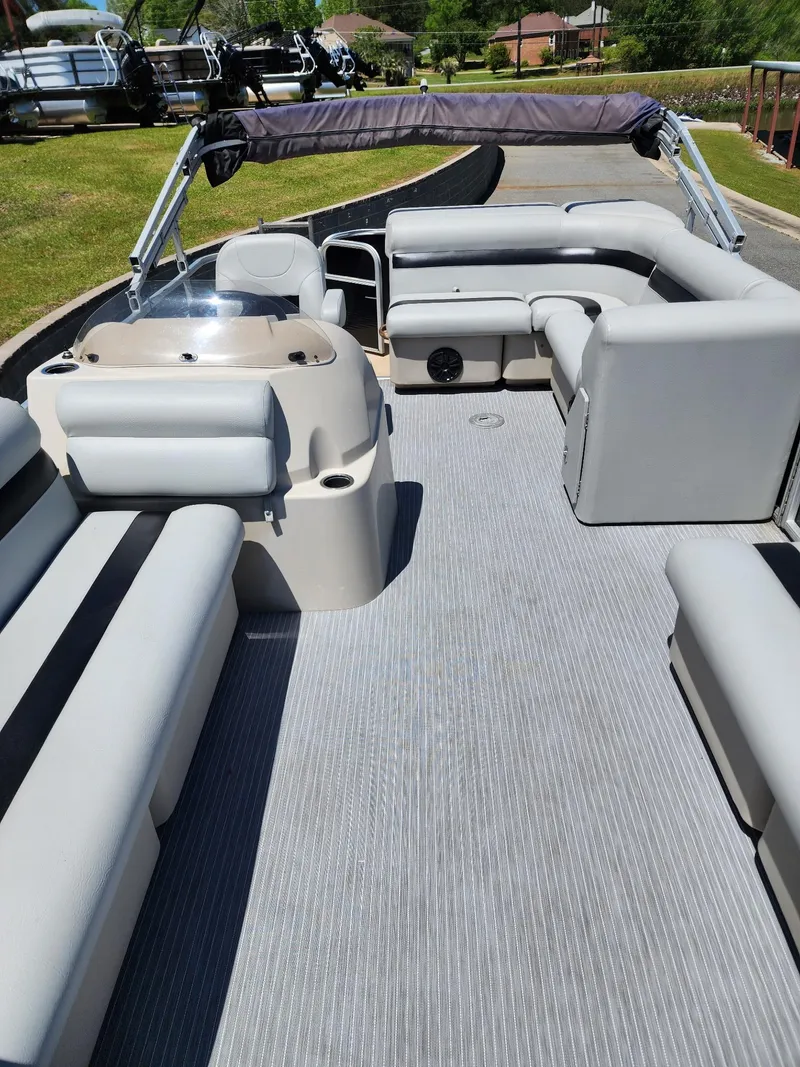 Slide: The Image of 2012 Sweetwater SW 2086 pontoon boat with gray seating and canopy on a sunny day. - 7