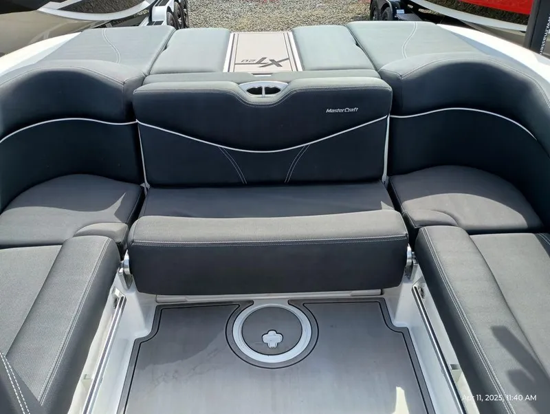 Slide: The Image of 2021 MasterCraft XT20 boat interior with cushioned seating and sleek design. - 10