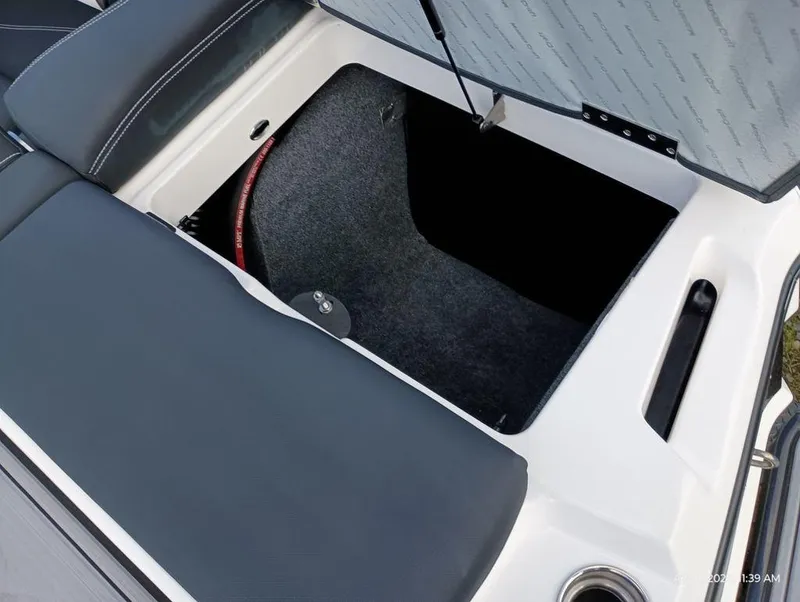 Slide: The Image of Open storage compartment in 2021 MasterCraft XT20 boat. - 11