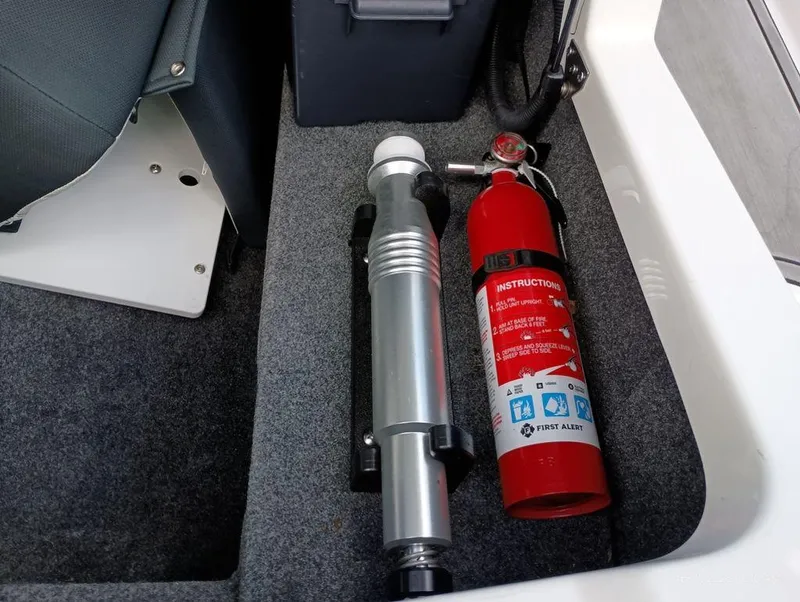 Slide: The Image of Fire extinguisher and equipment in 2021 MasterCraft XT20 boat storage compartment. - 12