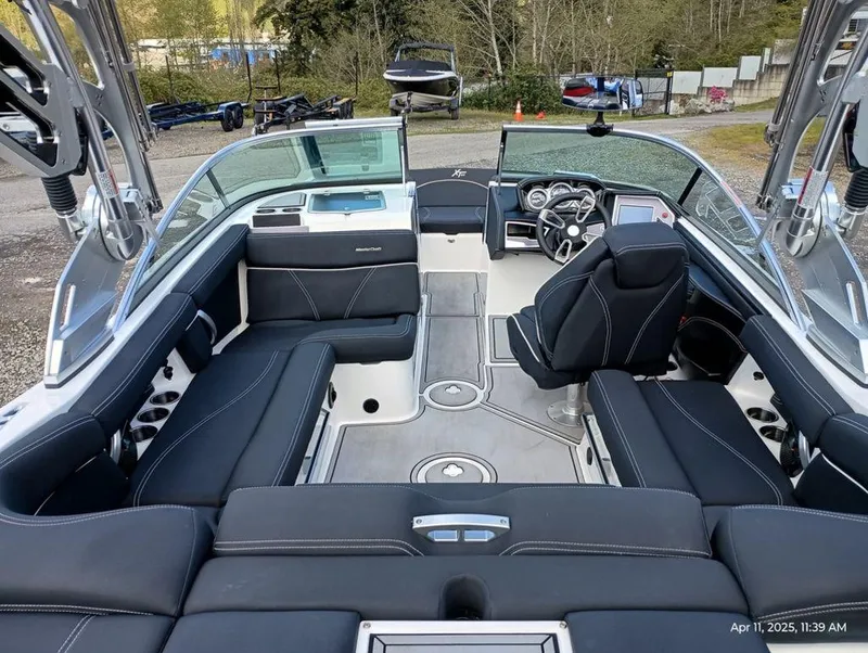 Slide: The Image of 2021 MasterCraft XT20 boat interior with black seating and modern dashboard. - 5