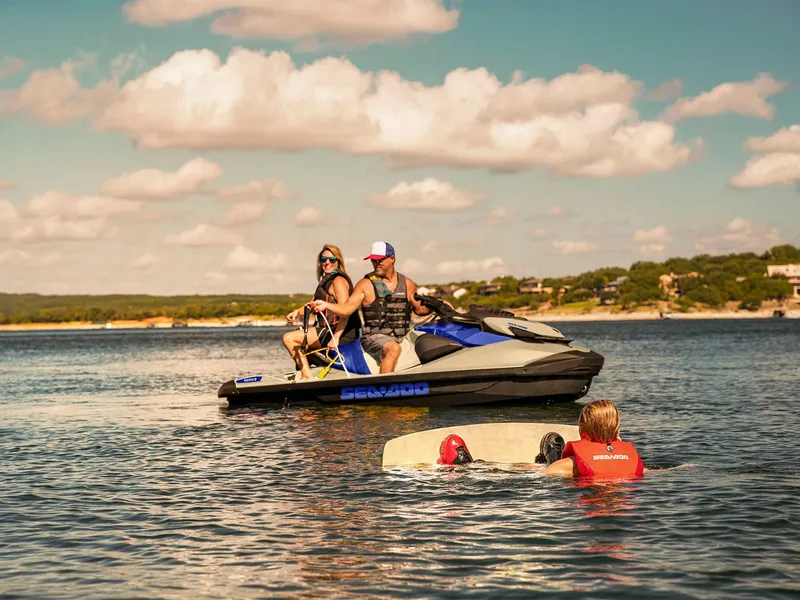 Slide: The Image of 2025 Sea-Doo Wake 170 with riders and wakeboarder on a sunny lake. - 16
