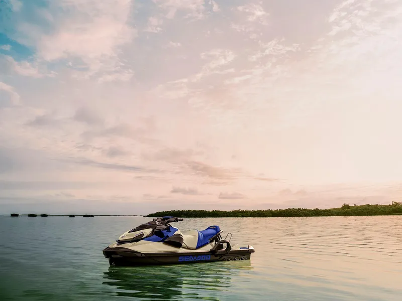 Slide: The Image of 2025 Sea-Doo Wake 170 jet ski on calm water at sunset. - 17