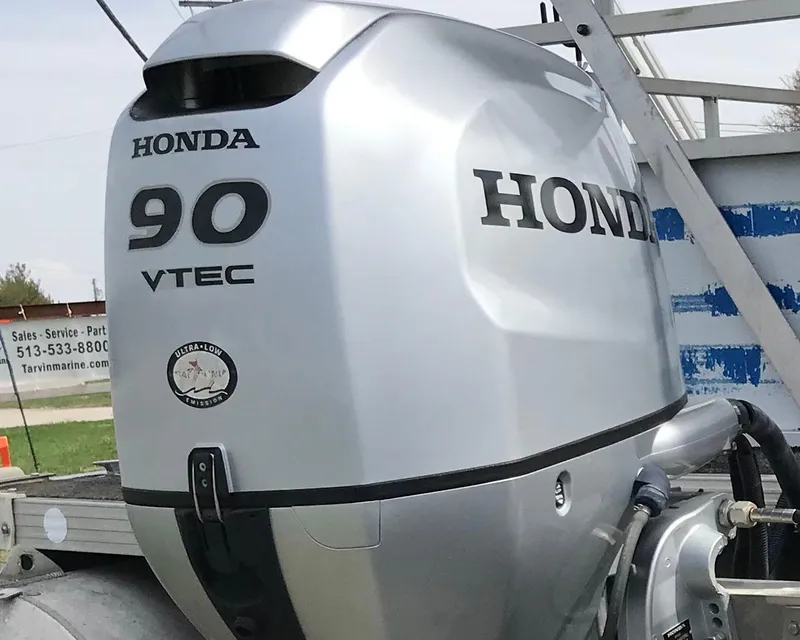 Slide: The Image of Silver Honda 90 VTEC outboard motor on a 1995 Manitou 24 Spirit boat. - 4
