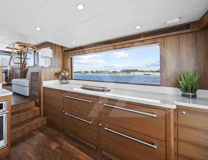 Slide: The Image of Interior of 2023 Outer Reef Yachts 720 Azure, featuring elegant wood cabinetry and ocean view. - 19