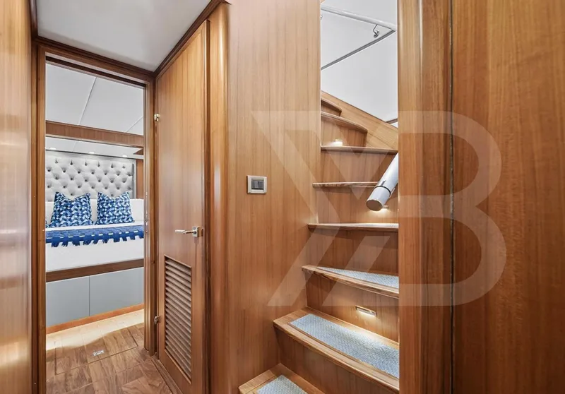 Slide: The Image of Luxurious interior of 2023 Outer Reef Yachts 720 Azure, featuring wooden stairs and elegant bedroom. - 27