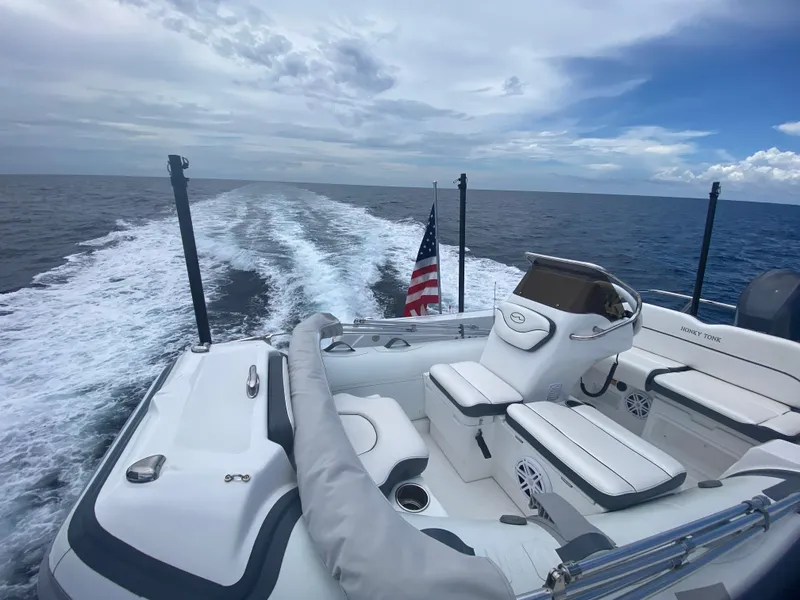 Slide: The Image of 2023 Outer Reef Yachts 720 Azure Motoryacht cruising on open sea with American flag. - 39