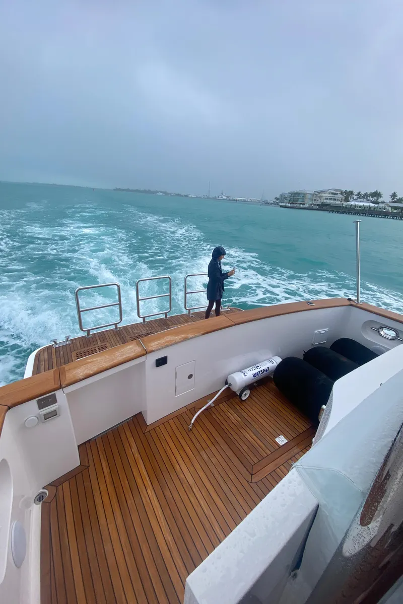 Slide: The Image of 2023 Outer Reef Yachts 720 Azure cruising on open water, featuring a spacious wooden deck. - 40