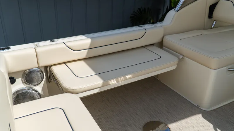 Slide: The Image of 2025 Chris-Craft Calypso 28 interior with beige seating and integrated speakers. - 17