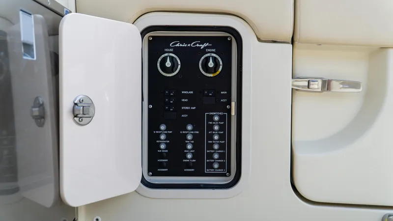 Slide: The Image of Control panel on 2025 Chris-Craft Calypso 28 boat, featuring various switches and dials. - 28