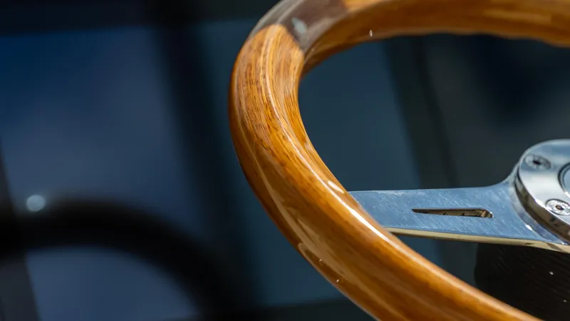 Slide: The Image of Wooden steering wheel of 2025 Chris-Craft Calypso 28 boat, close-up view. - 37