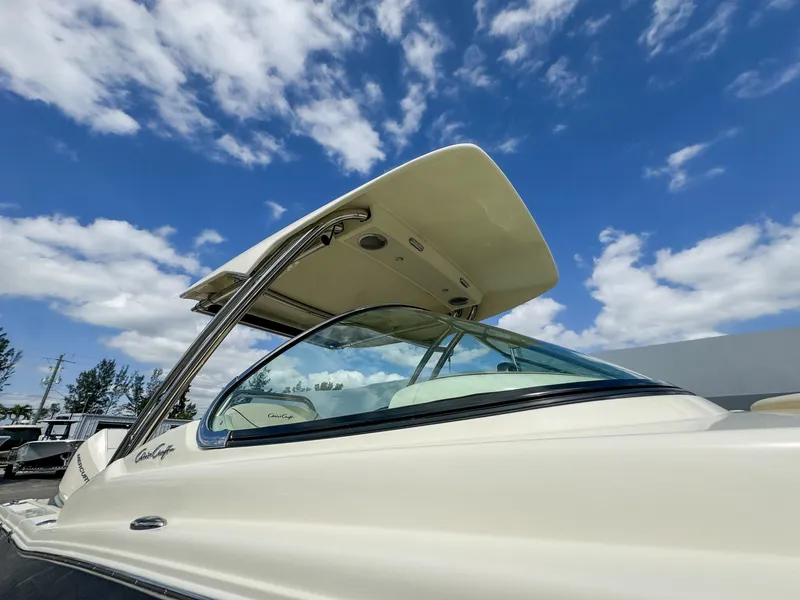 Slide: The Image of 2025 Chris-Craft Calypso 28 boat under a clear blue sky with clouds. - 4