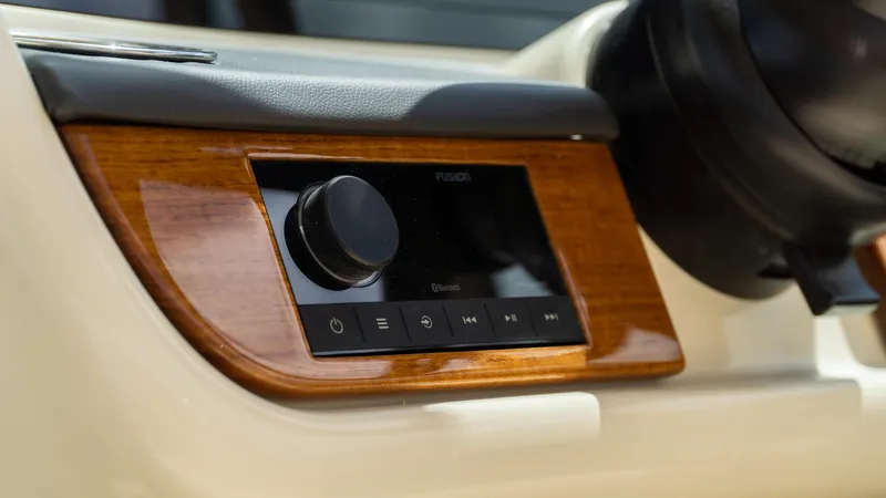 Slide: The Image of 2025 Chris-Craft Calypso 28 dashboard with sleek audio control panel. - 40