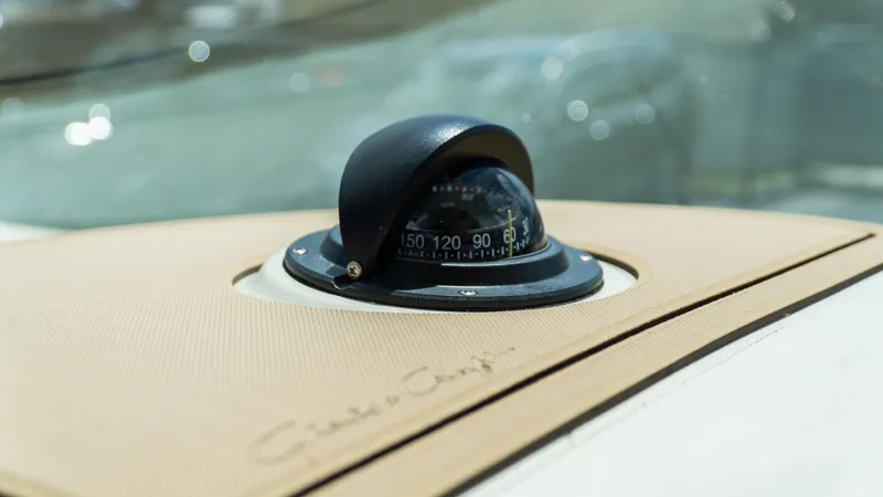 Slide: The Image of Compass on 2025 Chris-Craft Calypso 28 boat dashboard, featuring elegant design. - 44