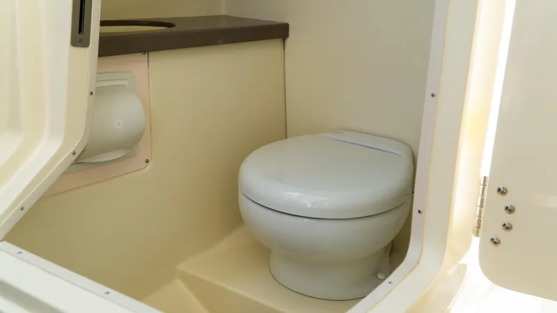 Slide: The Image of 2025 Chris-Craft Calypso 28 boat interior bathroom with toilet and countertop. - 48
