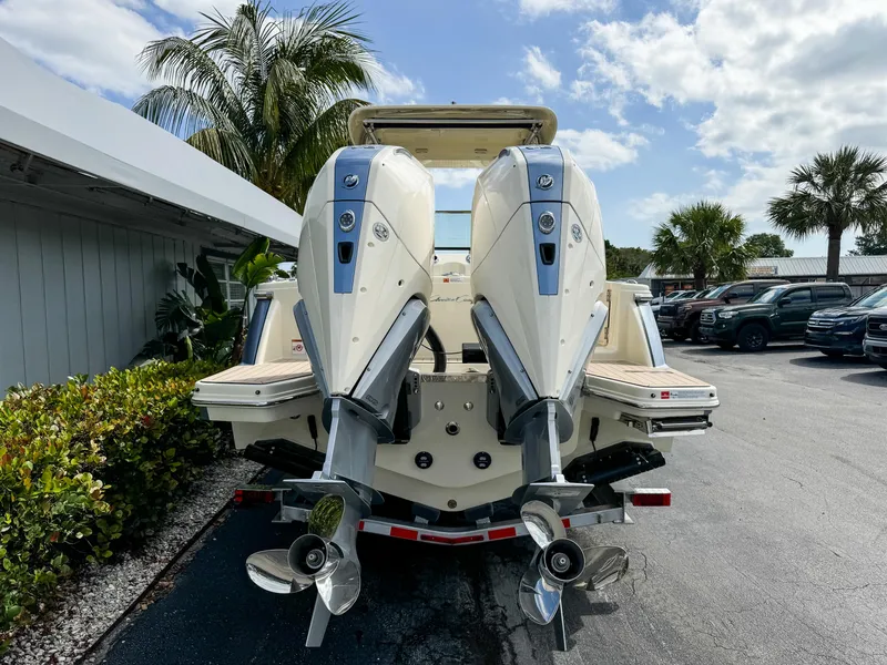 Slide: The Image of 2025 Chris-Craft Calypso 28 with dual outboard engines, parked outdoors. - 6