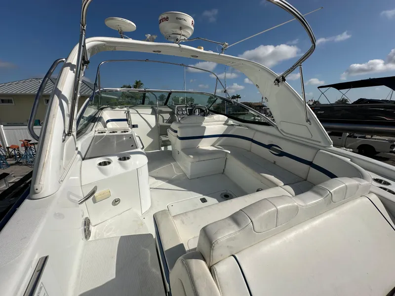 Slide: The Image of 2011 Formula 350 Sun Sport boat interior with white seating and open deck under blue sky. - 11