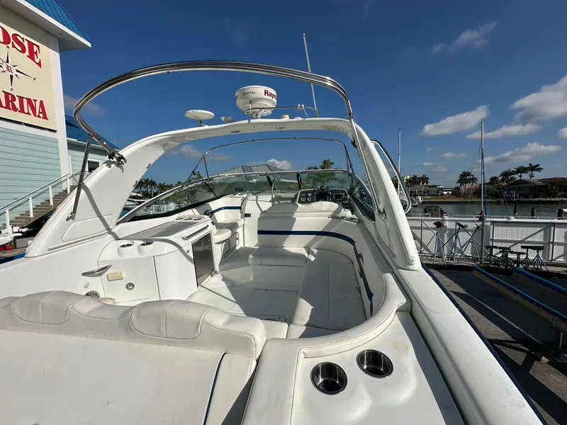 Slide: The Image of 2011 Formula 350 Sun Sport boat docked at marina under clear blue sky. - 12