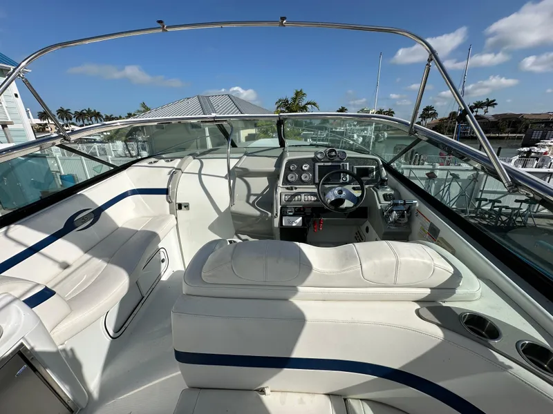 Slide: The Image of 2011 Formula 350 Sun Sport boat interior with white seating and control panel. - 13