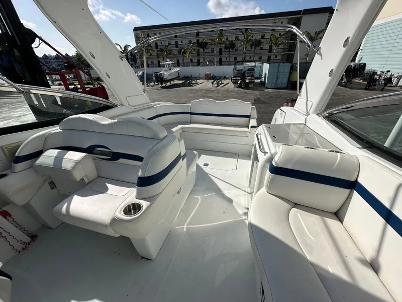 Slide: The Image of 2011 Formula 350 Sun Sport boat interior with white seating and blue accents. - 14