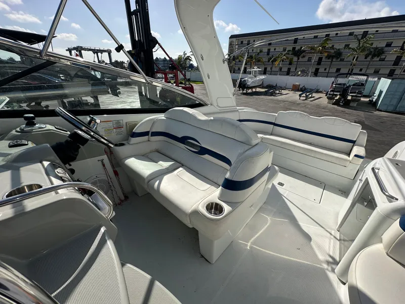 Slide: The Image of 2011 Formula 350 Sun Sport boat interior with white seating and steering area. - 15