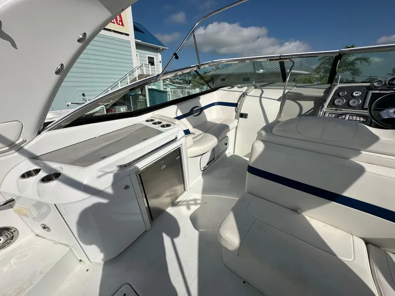 Slide: The Image of 2011 Formula 350 Sun Sport boat interior with seating, control panel, and mini-fridge. - 16