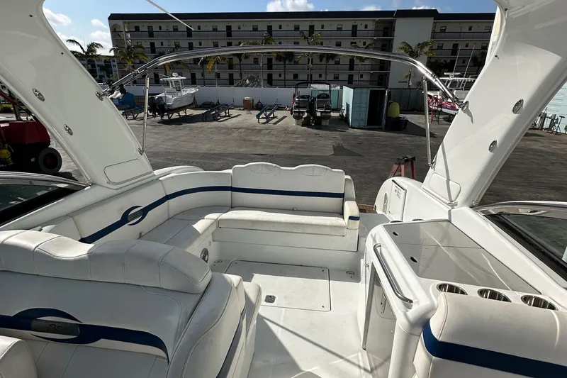 Slide: The Image of 2011 Formula 350 Sun Sport boat interior with white seating and marina view. - 17