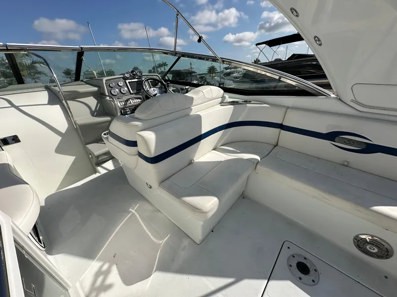 Slide: The Image of 2011 Formula 350 Sun Sport boat interior with white seating and control panel. - 18