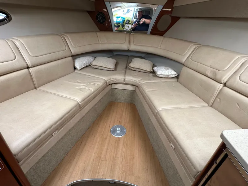 Slide: The Image of 2011 Formula 350 Sun Sport cabin with beige seating and wooden flooring. - 19