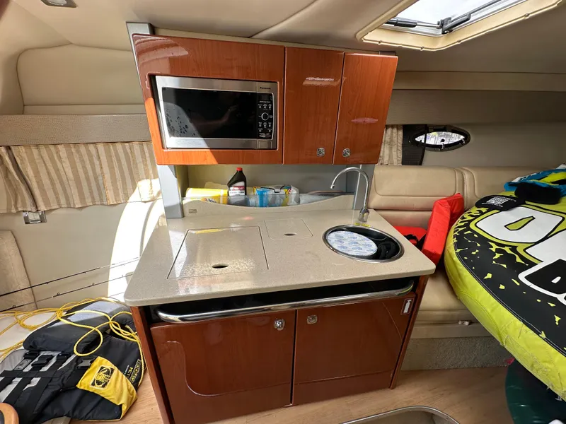 Slide: The Image of Interior of 2011 Formula 350 Sun Sport boat with kitchenette and seating area. - 20