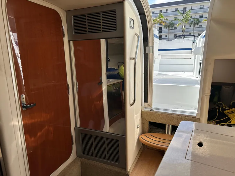 Slide: The Image of Interior view of 2011 Formula 350 Sun Sport boat, featuring cabin door and seating area. - 21