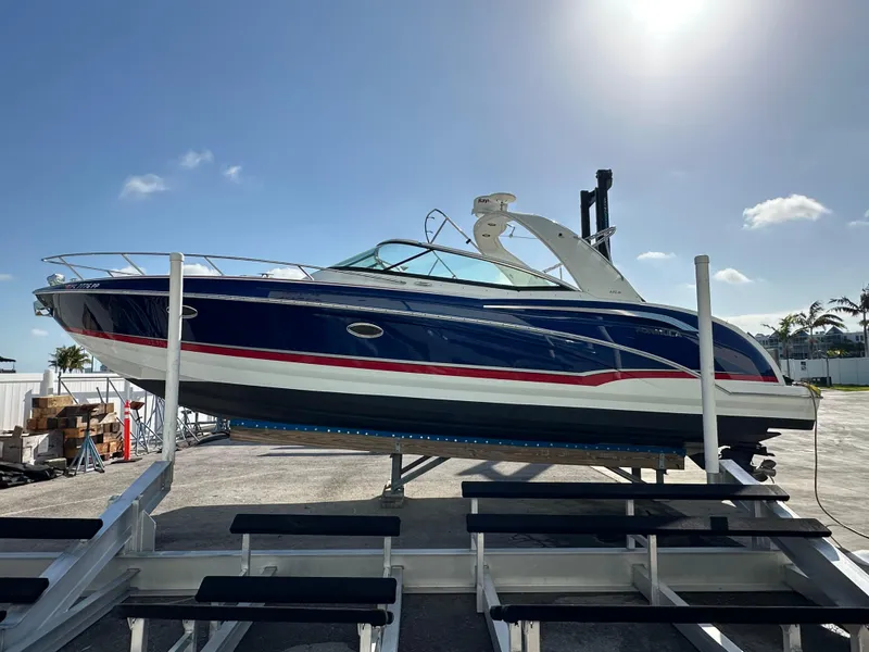 Slide: The Image of 2011 Formula 350 Sun Sport boat on a lift under a clear sky. - 3