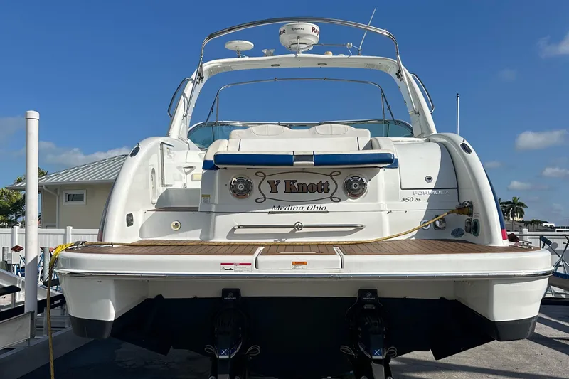 Slide: The Image of 2011 Formula 350 Sun Sport boat docked, rear view, clear sky background. - 5