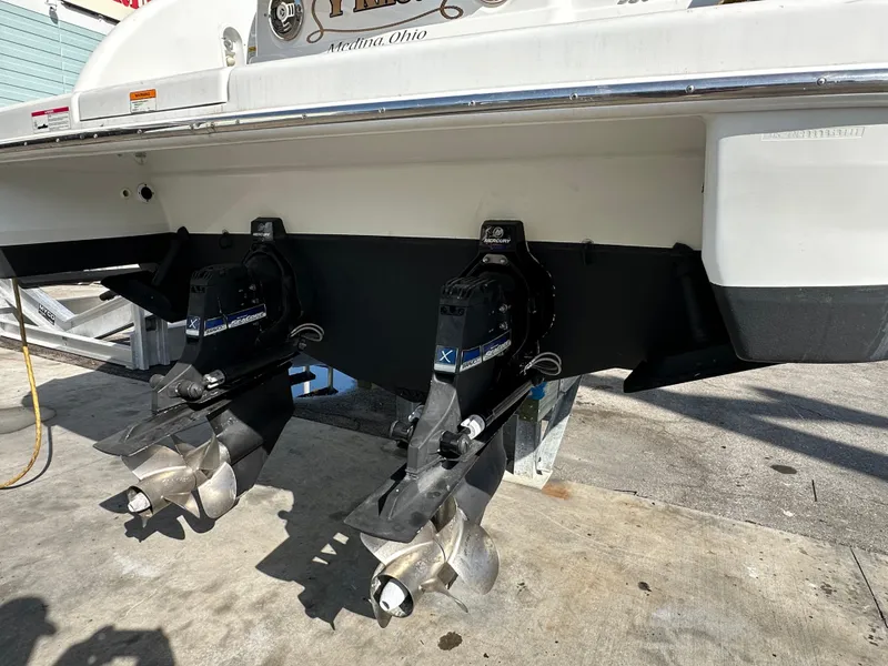 Slide: The Image of 2011 Formula 350 Sun Sport boat with dual outboard motors, docked on a sunny day. - 6