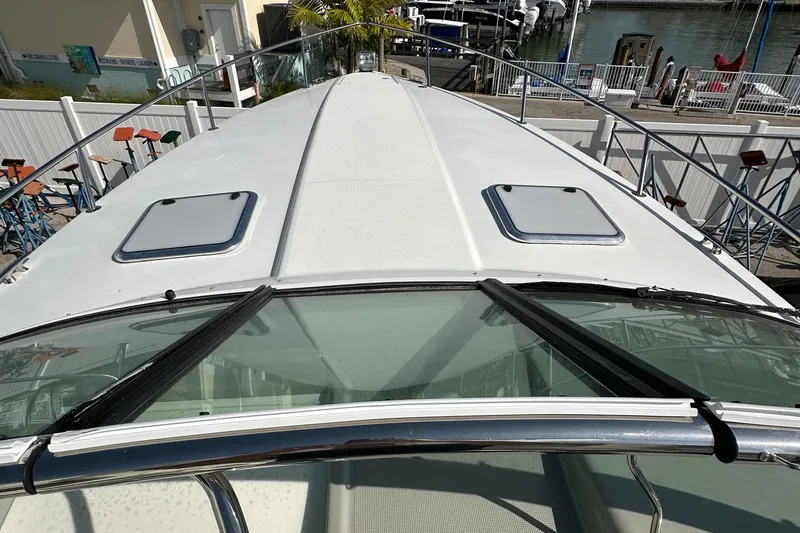 Slide: The Image of 2011 Formula 350 Sun Sport boat deck with hatches, docked at marina. - 9