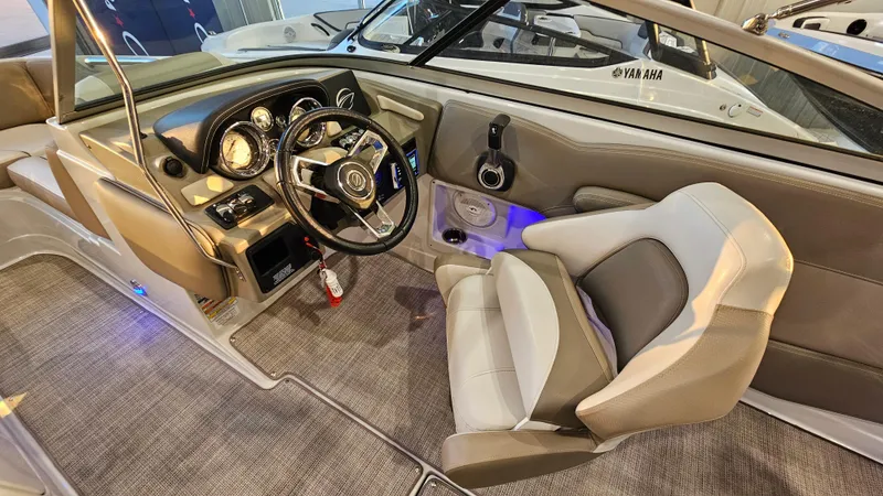 Slide: The Image of 2020 Crownline Eclipse E215 XS boat interior with steering wheel and seating. - 16