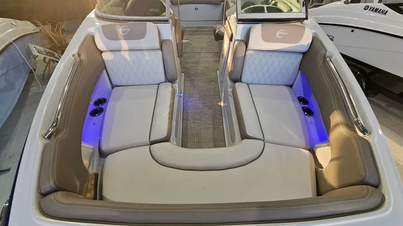Slide: The Image of 2020 Crownline Eclipse E215 XS boat interior with cushioned seating and ambient lighting. - 19