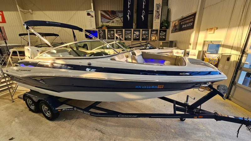 Slide: The Image of 2020 Crownline Eclipse E215 XS boat on trailer in showroom. - 2
