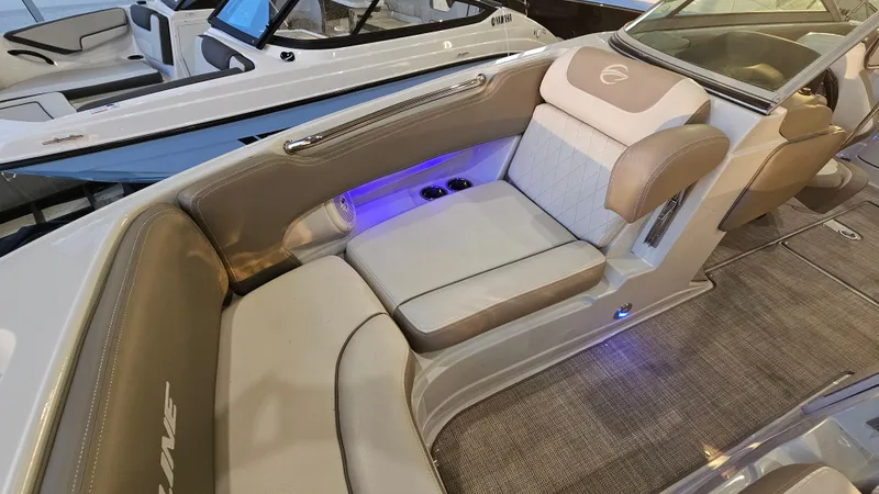 Slide: The Image of 2020 Crownline Eclipse E215 XS boat interior with plush seating and ambient lighting. - 20