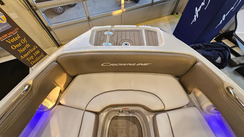Slide: The Image of 2020 Crownline Eclipse E215 XS boat interior with cushioned seating and ambient lighting. - 22