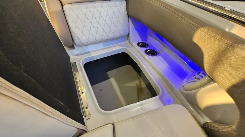 Slide: The Image of Interior of 2020 Crownline Eclipse E215 XS boat with storage compartment and blue LED lighting. - 26
