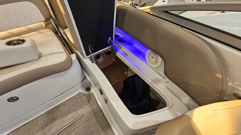 Slide: The Image of 2020 Crownline Eclipse E215 XS interior with storage compartment and ambient lighting. - 27