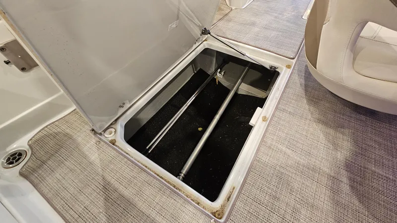 Slide: The Image of 2020 Crownline Eclipse E215 XS boat storage compartment with open hatch, revealing interior space. - 28