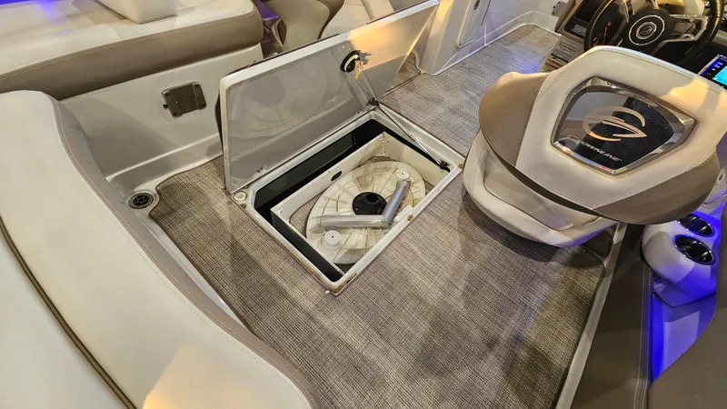 Slide: The Image of 2020 Crownline Eclipse E215 XS boat interior with open storage compartment and seating. - 29
