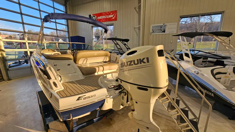 Slide: The Image of 2020 Crownline Eclipse E215 XS boat with Suzuki outboard motor in showroom. - 5