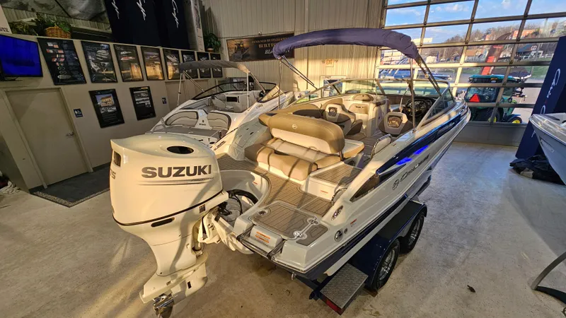 Slide: The Image of 2020 Crownline Eclipse E215 XS boat with Suzuki outboard motor in showroom. - 6
