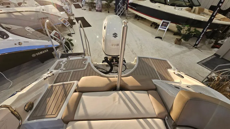 Slide: The Image of 2020 Crownline Eclipse E215 XS boat interior with Suzuki engine, displayed at a showroom. - 9