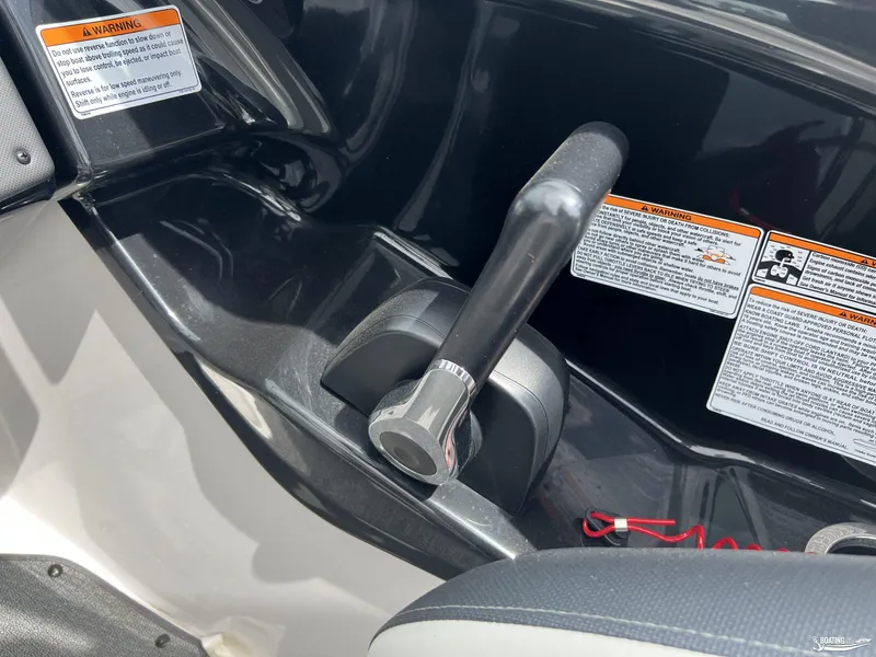 Slide: The Image of Close-up of 2018 Yamaha AR195 boat throttle control with warning labels. - 11