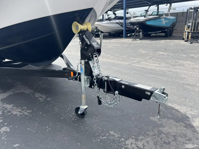 Slide: The Image of 2018 Yamaha AR195 boat trailer hitch with chains and wheel on asphalt. - 13